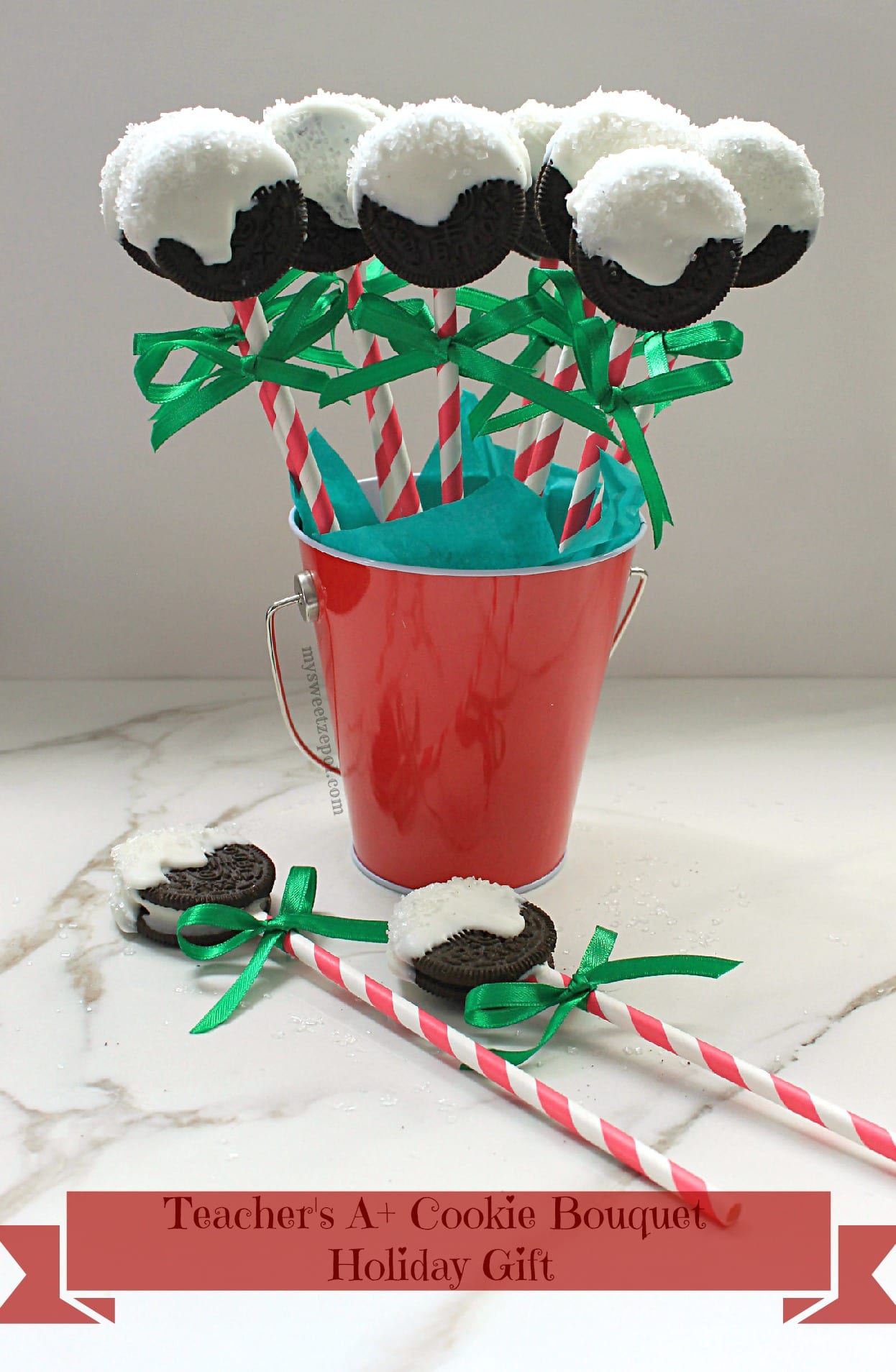 stuffed Oreo cookie bouquet for the holidays in red tin with white and red paper straws and green ribbon