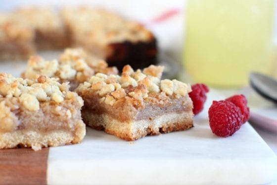Pink Lemonade Crumb Bars with a refreshing lemonade drink served in a mason jar with fresh raspberries in a cute pink bowl. The best dessert to welcome Spring. Grab the recipe at mysweetzepol.com #EasterSweetsWeek #ad