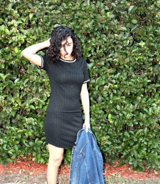 Black dress with jean jacket at hand. Perfect Spring street style outfit. 