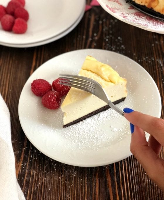 The Best Dairy Free Cheesecake with fresh raspberries and chocolate graham crust