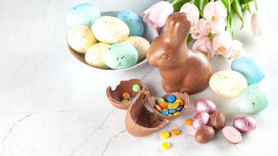 Chocolate Easter bunny with Easter candies and Easter Eggs