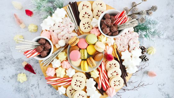 charcuterie board filled with sweet treats, candy cakes macaroons, cookies, peppermint pretzels, chocolates, Christmas trees / My Sweet Zepol